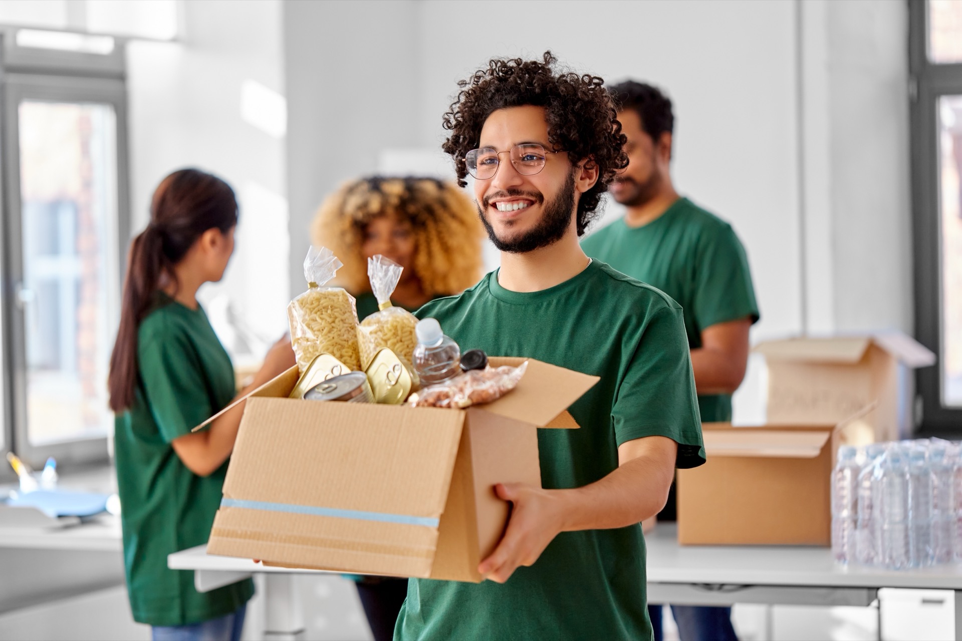 Volunteer worker carrying box of food
